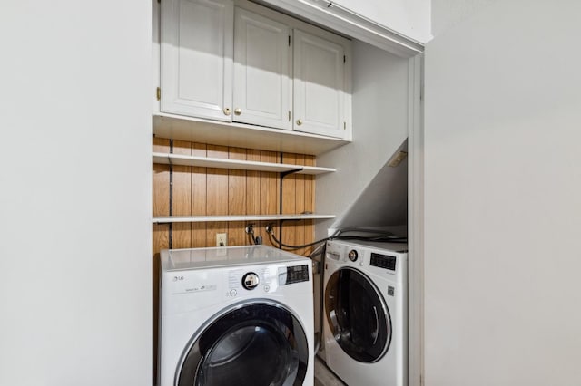 laundry room with cabinets and washer and dryer