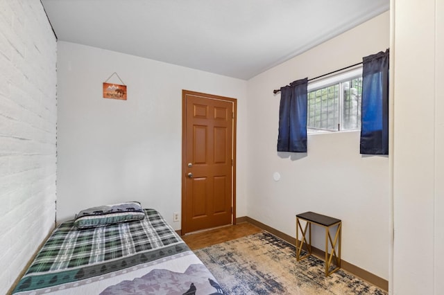 bedroom with wood finished floors and baseboards