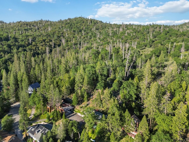 birds eye view of property featuring a view of trees