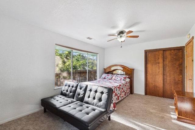 carpeted bedroom featuring ceiling fan and visible vents