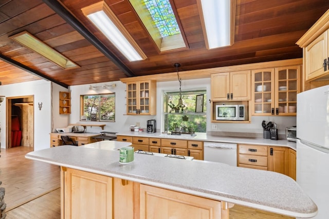 kitchen with wooden ceiling, a skylight, white appliances, and light brown cabinetry
