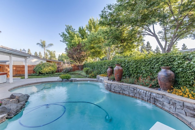 view of swimming pool with pool water feature