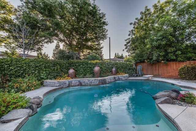 view of pool with a diving board