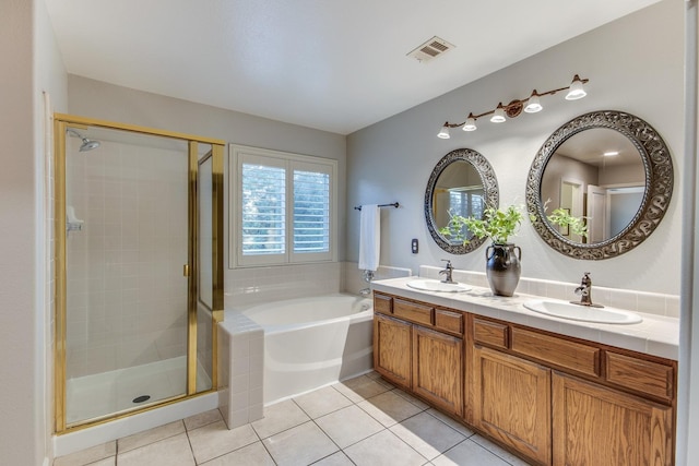 bathroom featuring tile patterned flooring, vanity, and separate shower and tub