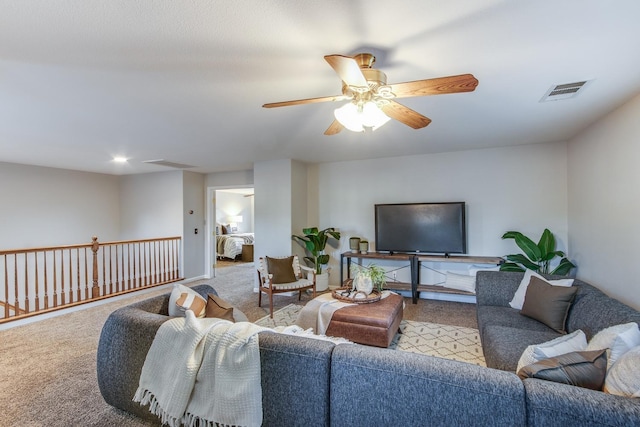 living room featuring light carpet and ceiling fan