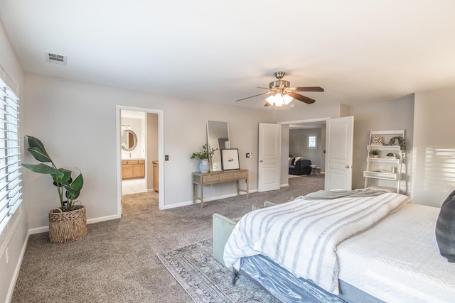 carpeted bedroom with ceiling fan and connected bathroom