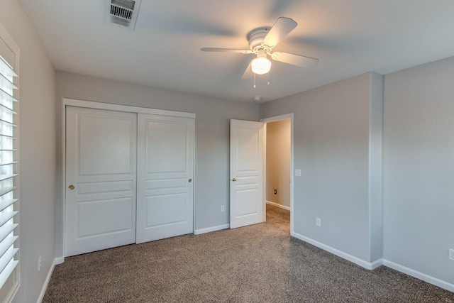 unfurnished bedroom featuring carpet, ceiling fan, and a closet