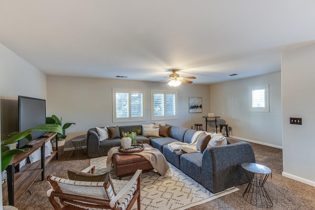 carpeted living room with ceiling fan