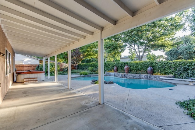 view of swimming pool featuring a patio area and a hot tub