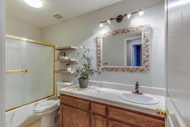 full bathroom featuring bath / shower combo with glass door, vanity, and toilet