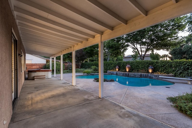 view of swimming pool with a hot tub and a patio area