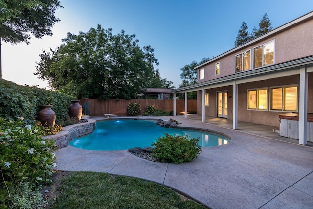 view of swimming pool featuring a diving board and a patio area