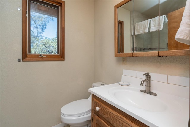 bathroom featuring oversized vanity and toilet