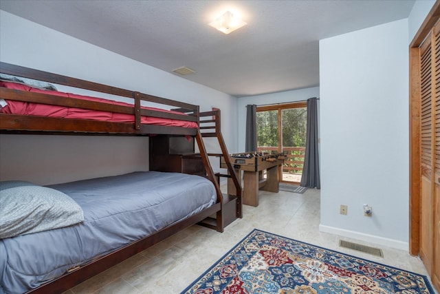 tiled bedroom with a closet