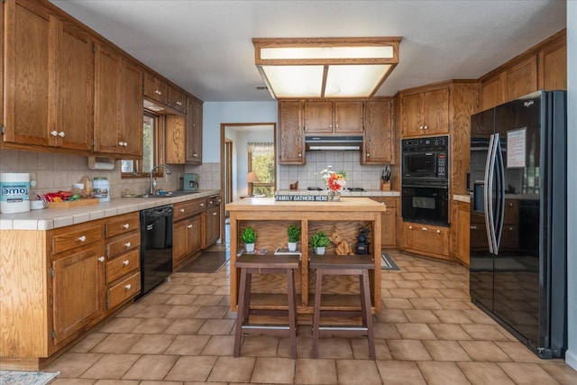 kitchen with black appliances, sink, backsplash, and light tile flooring