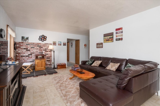 living room featuring a textured ceiling and light tile floors