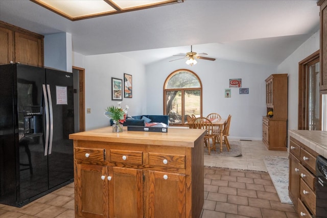 kitchen featuring ceiling fan, lofted ceiling, black appliances, and light tile floors