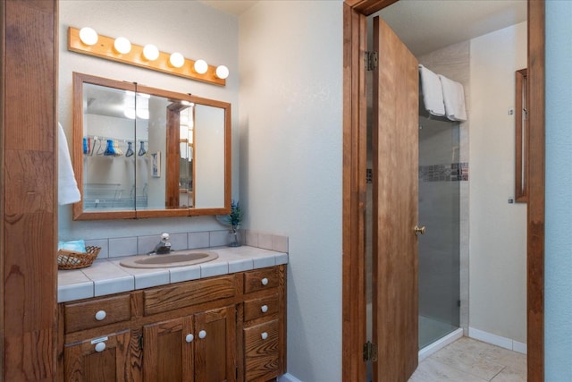 bathroom featuring walk in shower, tile flooring, and vanity