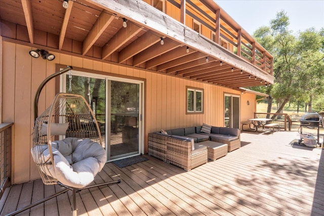 wooden deck with an outdoor living space