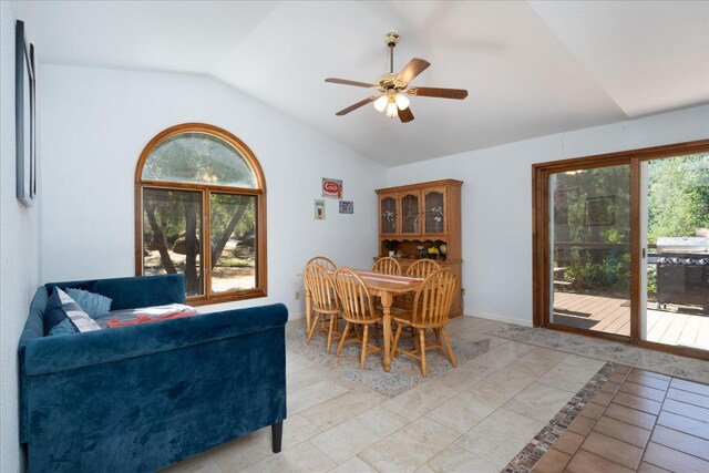 tiled dining area with lofted ceiling, plenty of natural light, and ceiling fan