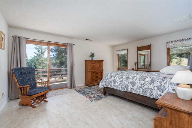 bedroom featuring access to exterior and light tile floors