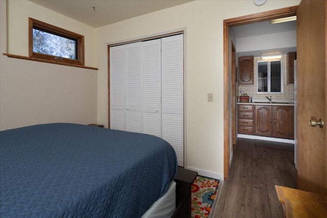 bedroom featuring dark hardwood / wood-style flooring and a closet