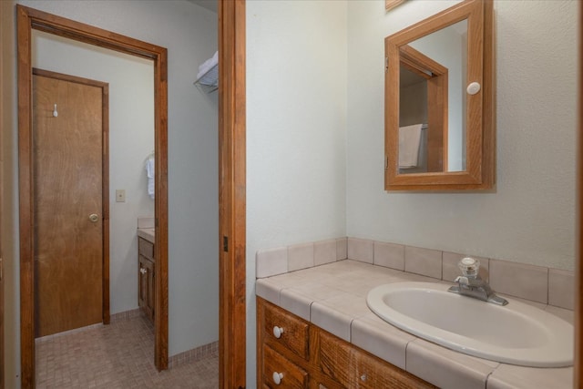 bathroom with vanity and tile floors