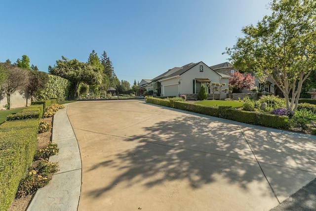 view of street featuring concrete driveway