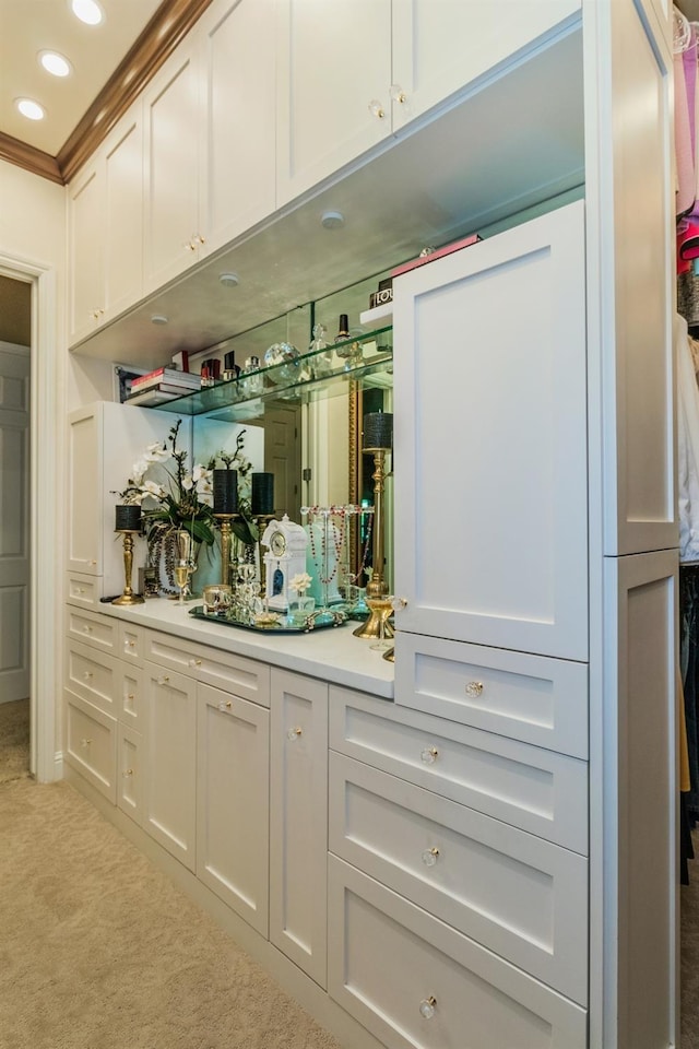 bar featuring recessed lighting, light colored carpet, and crown molding