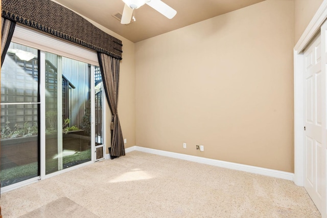 unfurnished room with a ceiling fan, carpet, and baseboards