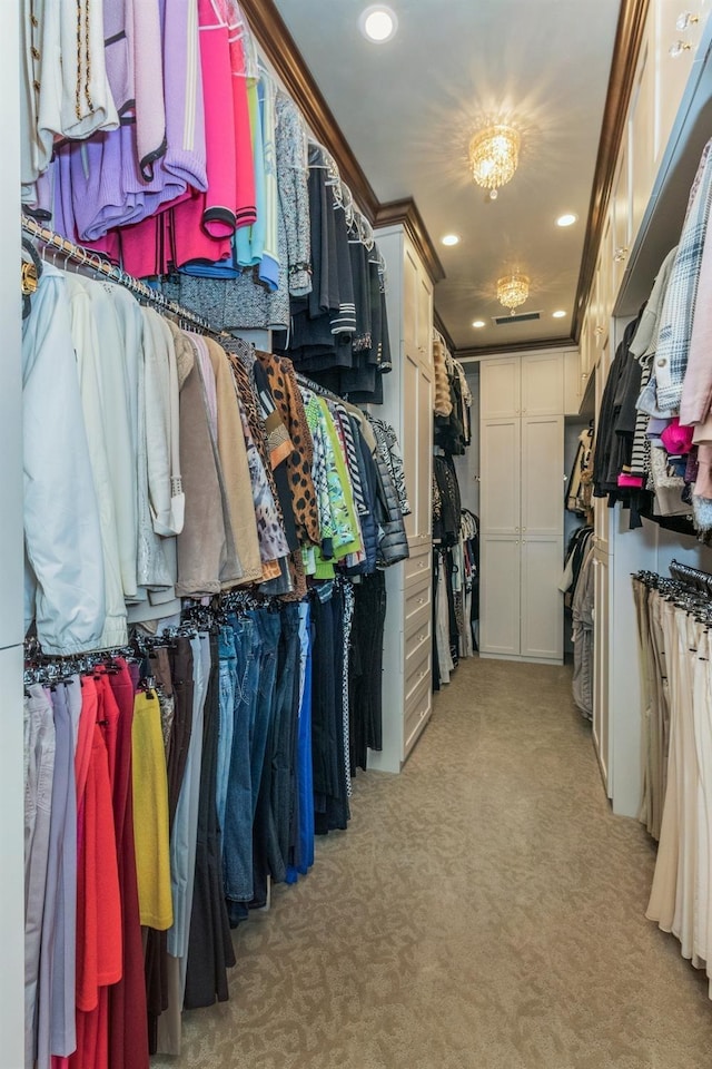 walk in closet with light carpet