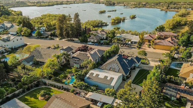 drone / aerial view featuring a residential view and a water view