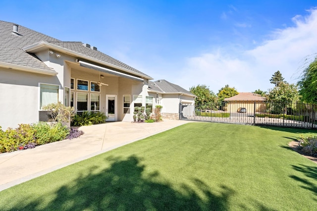 view of yard featuring a ceiling fan, fence, and a patio