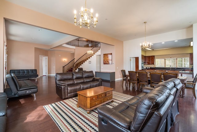 living room with a chandelier, sink, and dark hardwood / wood-style floors