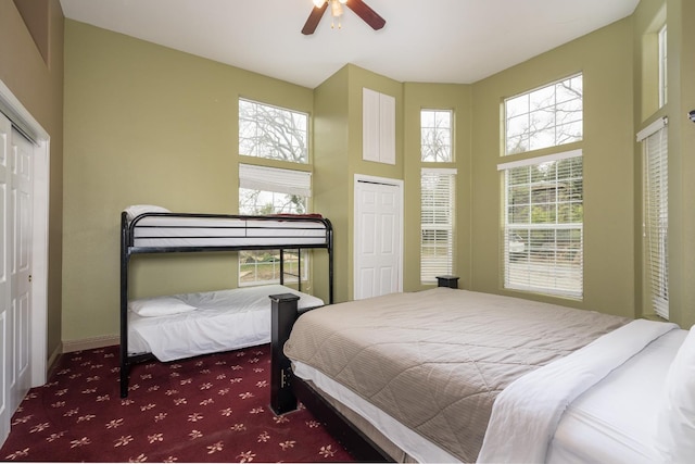 carpeted bedroom featuring ceiling fan and a towering ceiling