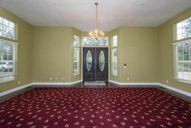 foyer featuring dark hardwood / wood-style floors and an inviting chandelier