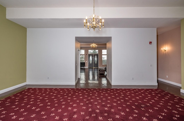 unfurnished room with a chandelier and hardwood / wood-style floors