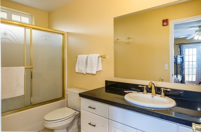 full bathroom with ceiling fan, bath / shower combo with glass door, toilet, and large vanity