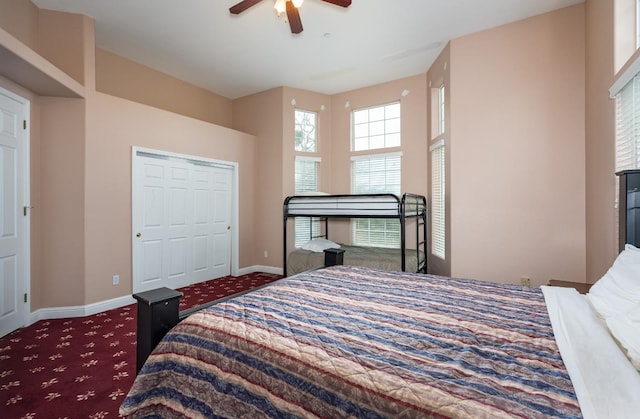 bedroom featuring a closet, ceiling fan, and dark carpet