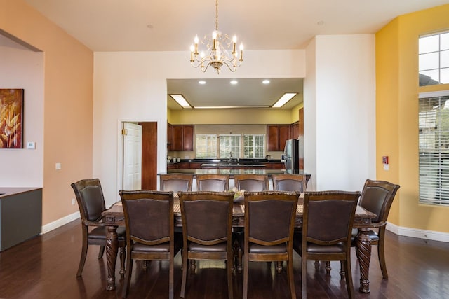 dining room with a notable chandelier and dark hardwood / wood-style flooring