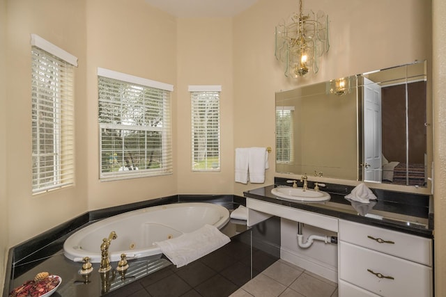 bathroom with tile floors, a relaxing tiled bath, plenty of natural light, and vanity