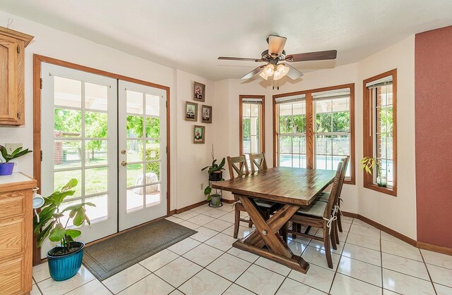 dining room with ceiling fan, french doors, and light tile patterned floors