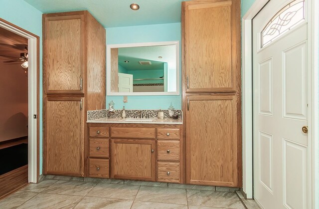 bathroom featuring ceiling fan and vanity