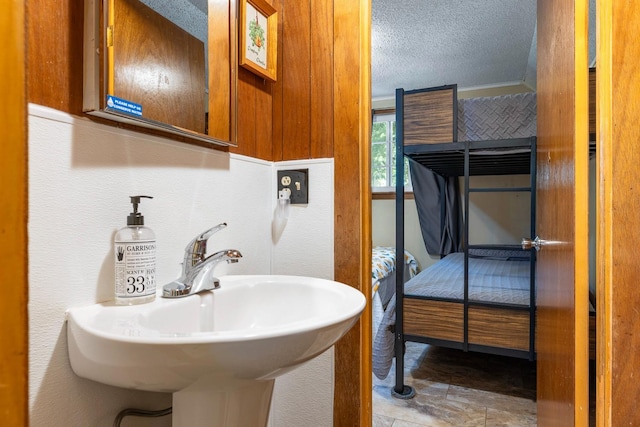 bathroom with sink and a textured ceiling