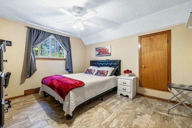 bedroom featuring a textured ceiling, ceiling fan, and lofted ceiling