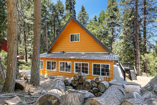 view of property exterior with a deck