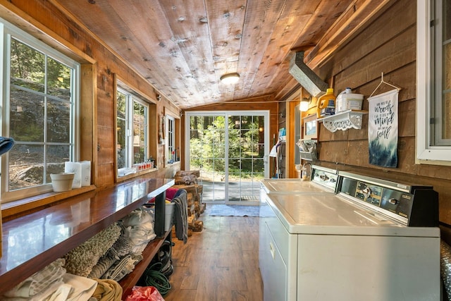 laundry room with wooden walls, dark hardwood / wood-style flooring, wood ceiling, and independent washer and dryer