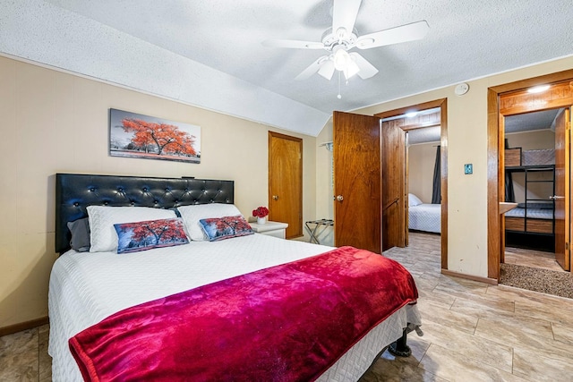 bedroom featuring ceiling fan and a textured ceiling