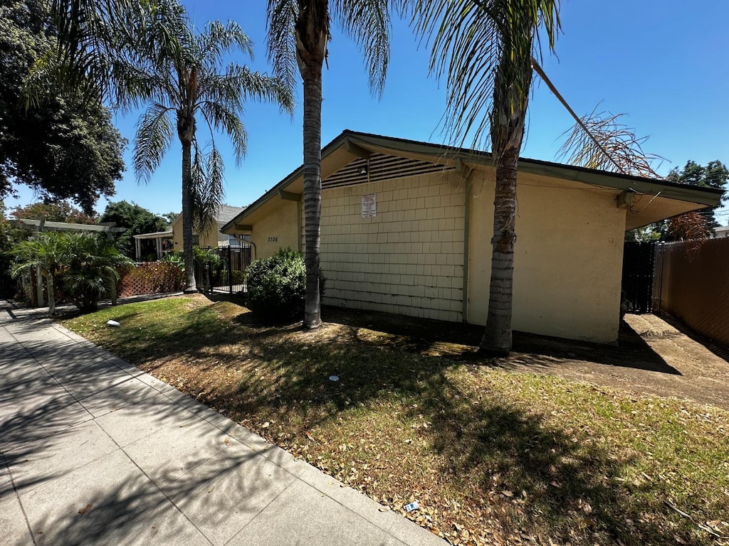 view of property exterior featuring a lawn