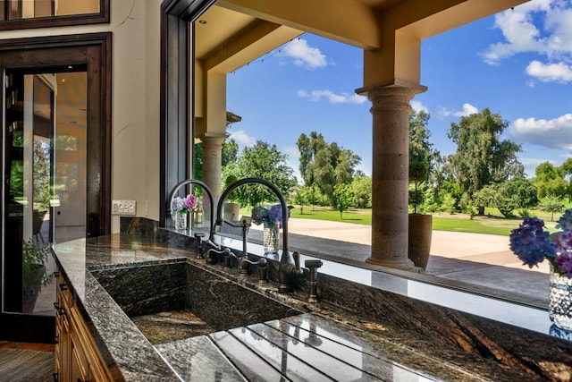 exterior details featuring decorative columns and dark stone countertops